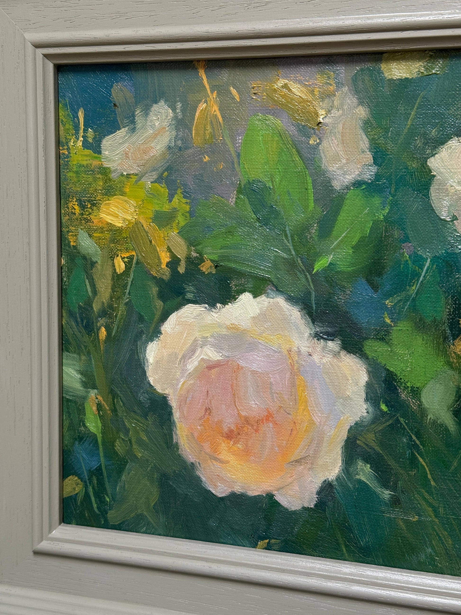 Framed oil painting of a pink rose with green leaves and yellow accents.