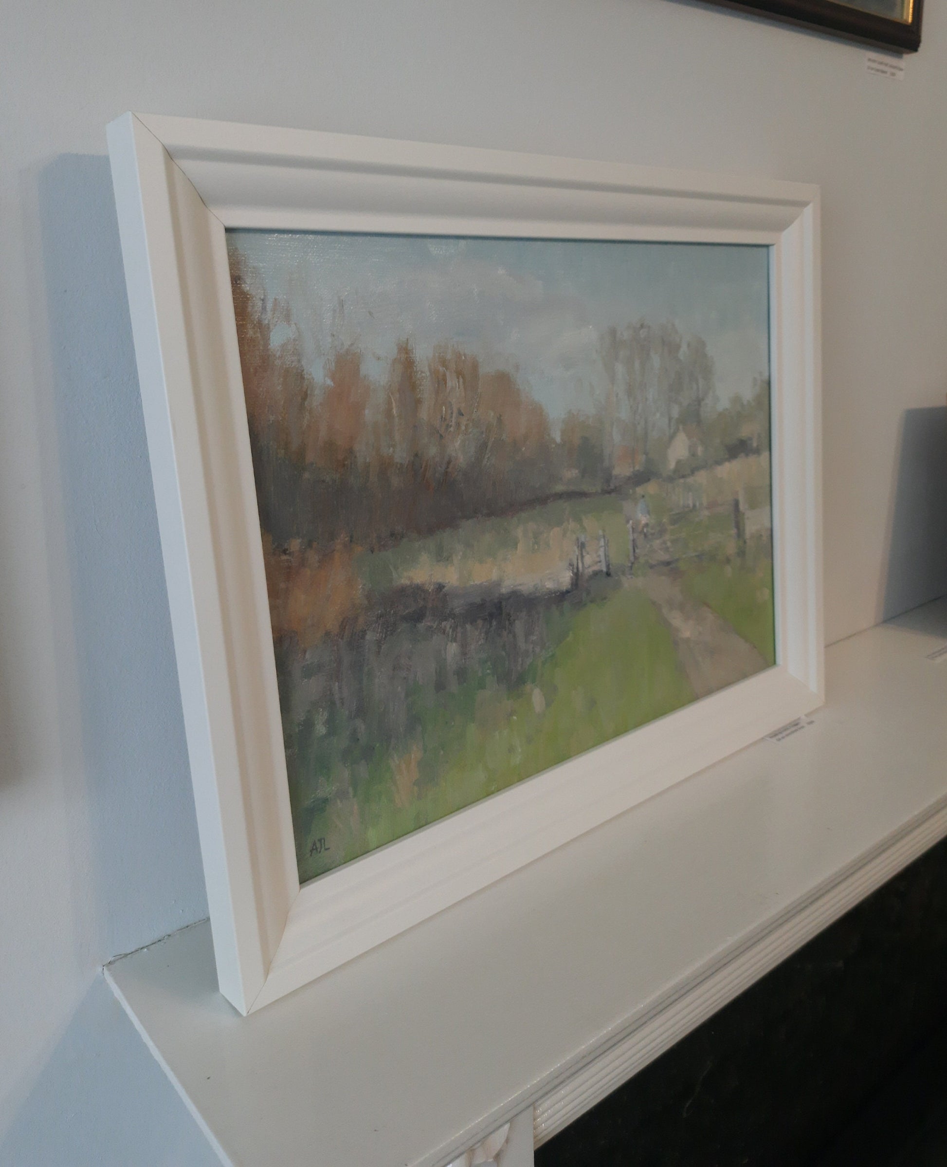 A side-view of the framed oil painting.