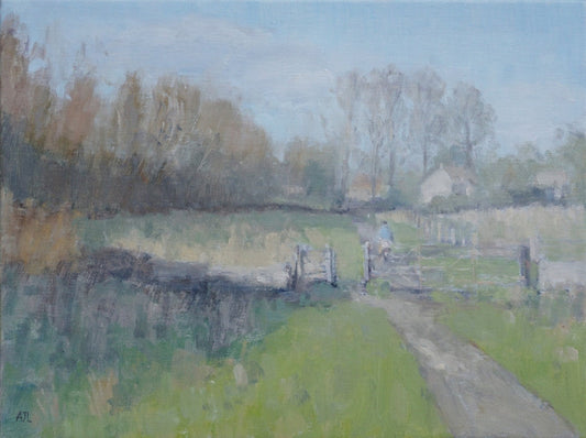 An original oil painting of the grounds at Cogges Manor Farm in the wintertime, with a man on a bike heading home on a path that cuts through the fields, a gated wall, and a line of trees in the background. The artist has signed AJL, for "Alex James Long", at the bottom left of the artwork. 